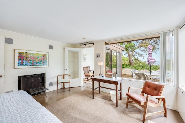 interior space with a tiled fireplace and a healthy amount of sunlight