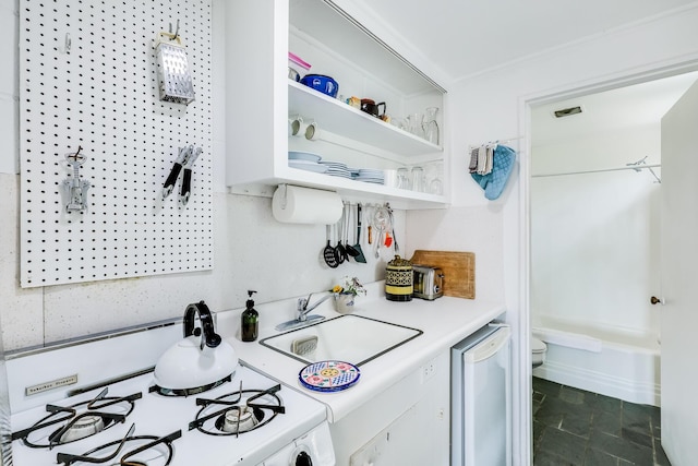 kitchen featuring sink and white gas range oven