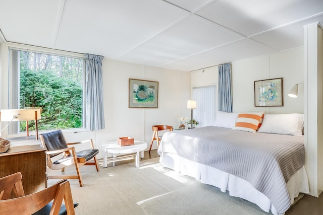 carpeted bedroom featuring multiple windows