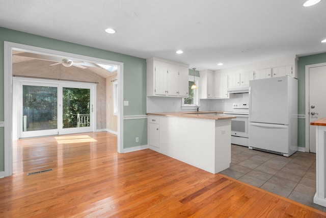 kitchen with white appliances, white cabinets, kitchen peninsula, ceiling fan, and light hardwood / wood-style flooring