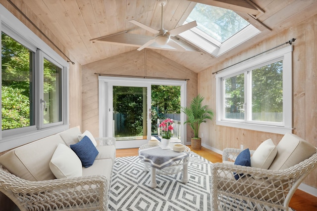 sunroom featuring wood ceiling, ceiling fan, and lofted ceiling with skylight