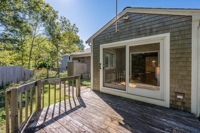 wooden deck featuring central air condition unit