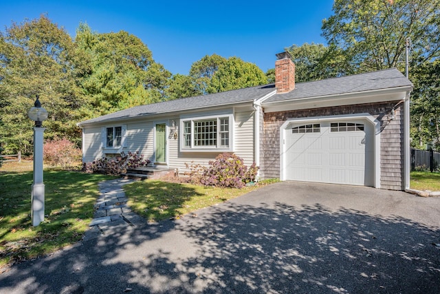 ranch-style home with a front yard and a garage