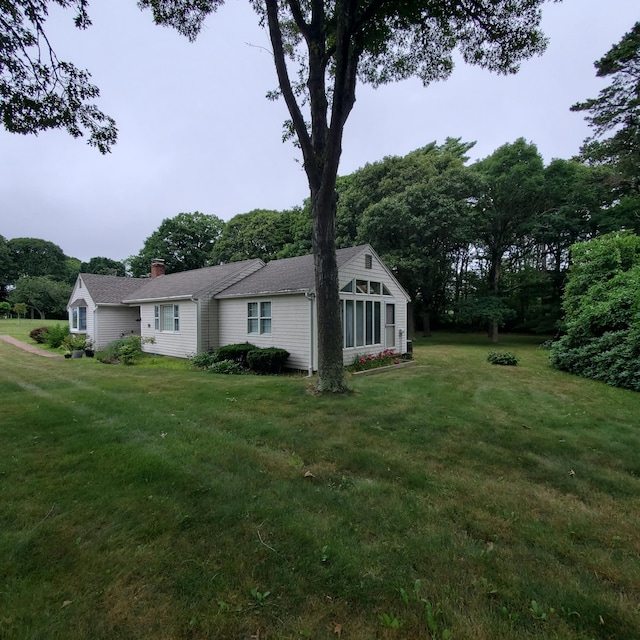 view of property exterior with a lawn