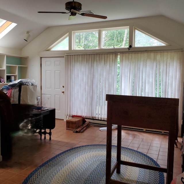 bedroom with ceiling fan, vaulted ceiling with skylight, wood walls, and tile patterned flooring