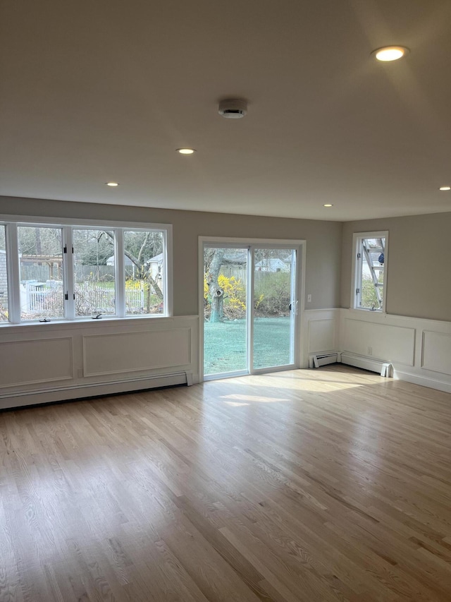 23 Town Hall Ave, South Yarmouth, MA 02664 - unfurnished room with wainscoting, a baseboard radiator, a decorative wall, and wood finished floors