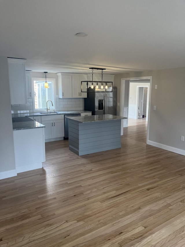 23 Town Hall Ave, South Yarmouth, MA 02664 - kitchen featuring white cabinets, stainless steel appliances, a sink, and light wood-style floors