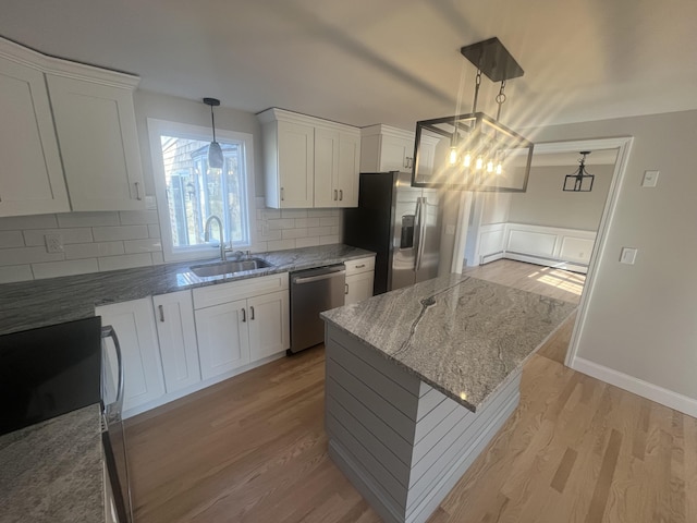 23 Town Hall Ave, South Yarmouth, MA 02664 - kitchen featuring light wood-type flooring, stainless steel appliances, a sink, and light stone counters