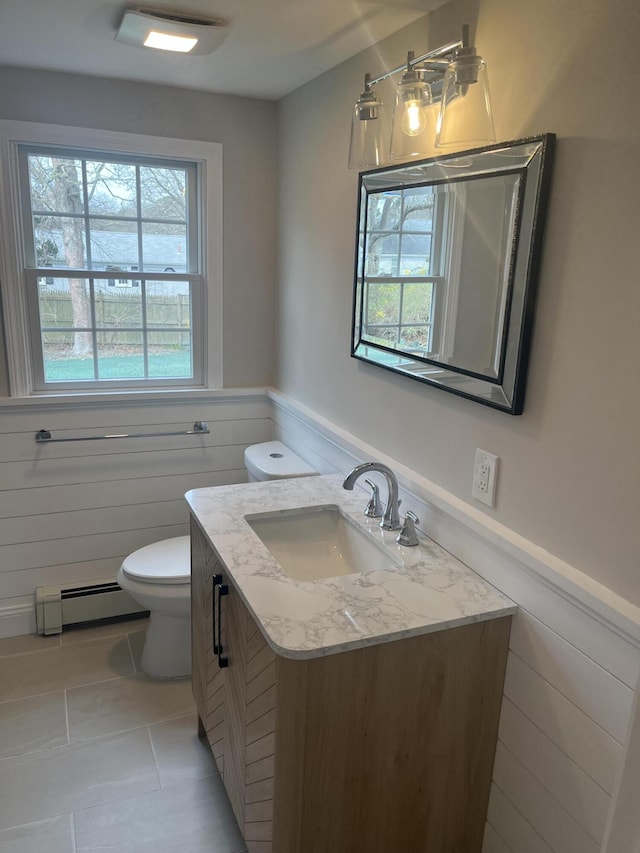 23 Town Hall Ave, South Yarmouth, MA 02664 - bathroom with toilet, wainscoting, tile patterned flooring, vanity, and a baseboard radiator