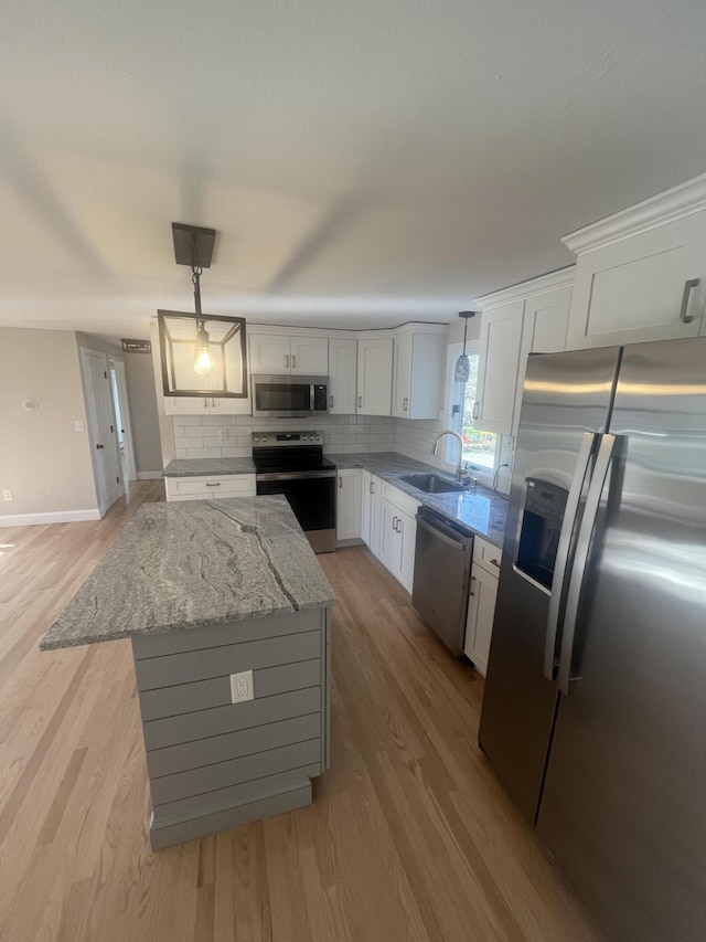 23 Town Hall Ave, South Yarmouth, MA 02664 - kitchen featuring white cabinets, stainless steel appliances, a sink, and tasteful backsplash