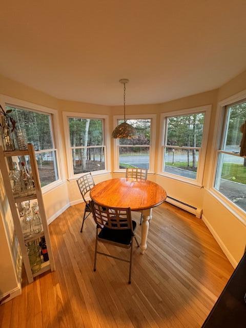 dining room with baseboard heating and light wood-type flooring