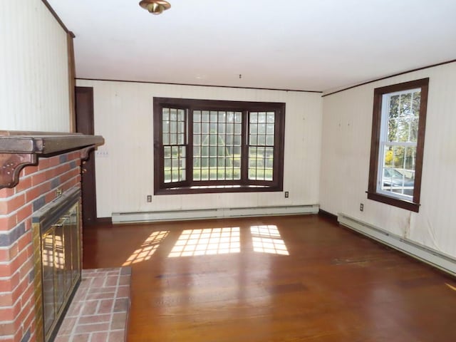 unfurnished living room featuring a baseboard radiator, a brick fireplace, and wood finished floors