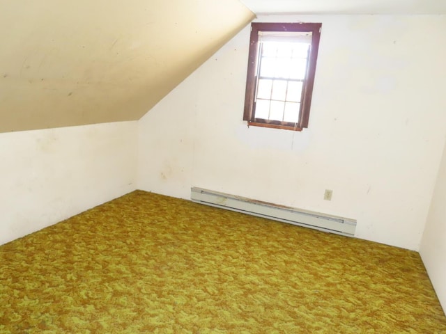additional living space with carpet, baseboard heating, and lofted ceiling