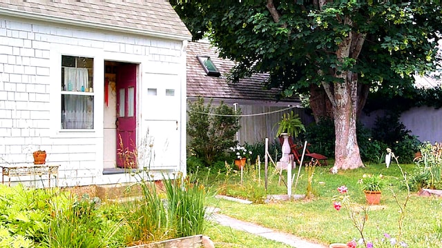 property entrance with a lawn