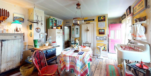 dining space with hardwood / wood-style flooring