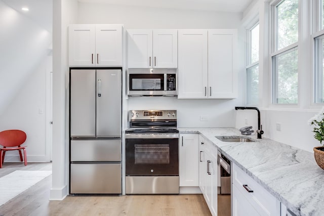 36 Pearl St Unit 3, Provincetown, MA 02657 - kitchen featuring appliances with stainless steel finishes, healthy amount of natural light, a sink, white cabinetry, and recessed lighting