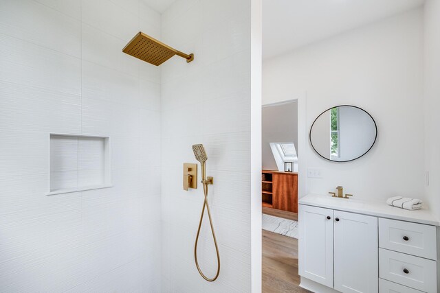 36 Pearl St Unit 3, Provincetown, MA 02657 - bathroom featuring tiled shower, vanity, and wood finished floors
