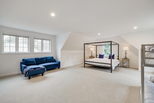 bedroom featuring light carpet and lofted ceiling