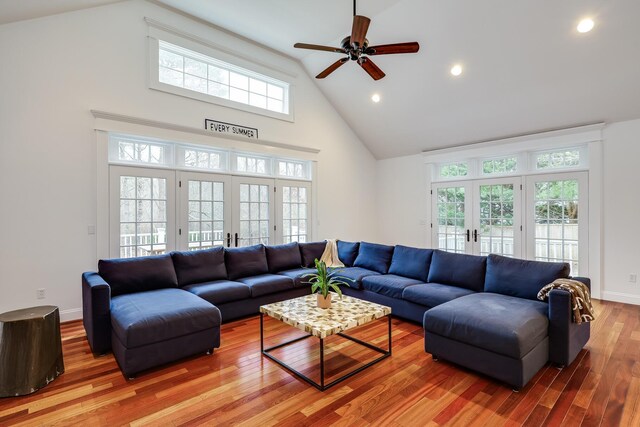 living room featuring hardwood / wood-style floors, high vaulted ceiling, ceiling fan, and french doors