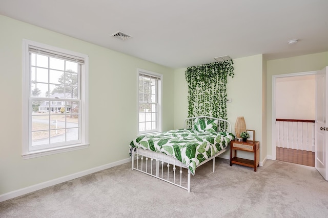 bedroom featuring light colored carpet