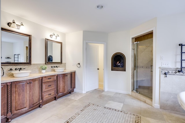 bathroom with a shower with shower door and vanity