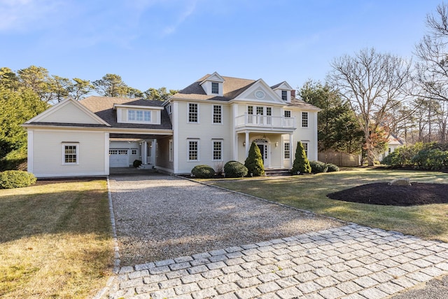 view of front of property with a balcony and a front yard