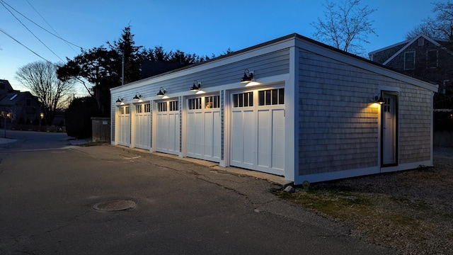 view of garage at dusk