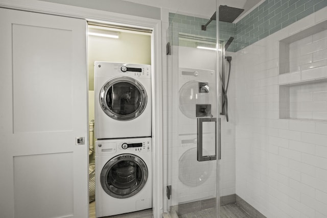 clothes washing area featuring stacked washer and dryer