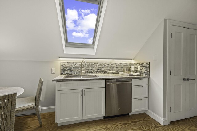 kitchen with white cabinets, tasteful backsplash, stainless steel dishwasher, and sink