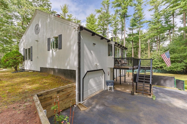 28 Brook St, Plympton, MA 02367 - view of property exterior featuring a garage, stairway, driveway, a deck, and view of wooded area
