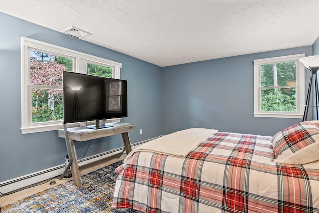 28 Brook St, Plympton, MA 02367 - bedroom featuring multiple windows, a textured ceiling, and a baseboard heating unit