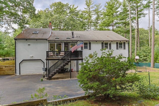 28 Brook St, Plympton, MA 02367 - back of house with asphalt driveway, a wooden deck, stairs, an attached garage, and a chimney