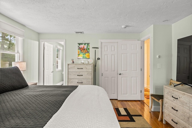28 Brook St, Plympton, MA 02367 - bedroom featuring wood finished floors, a textured ceiling, and a closet
