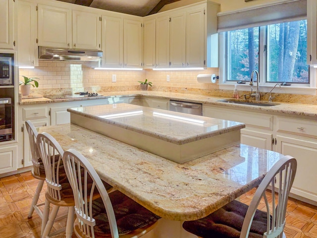 28 Brook St, Plympton, MA 02367 - kitchen with under cabinet range hood, stovetop, a center island, a breakfast bar, and a sink