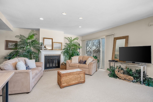 living area with recessed lighting, carpet floors, and a fireplace