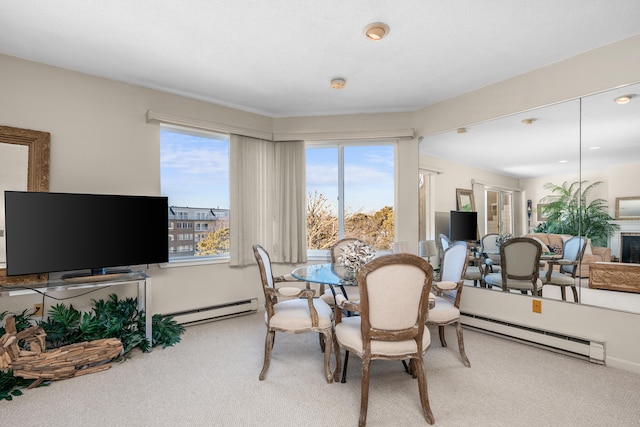 carpeted dining area featuring baseboard heating and a fireplace