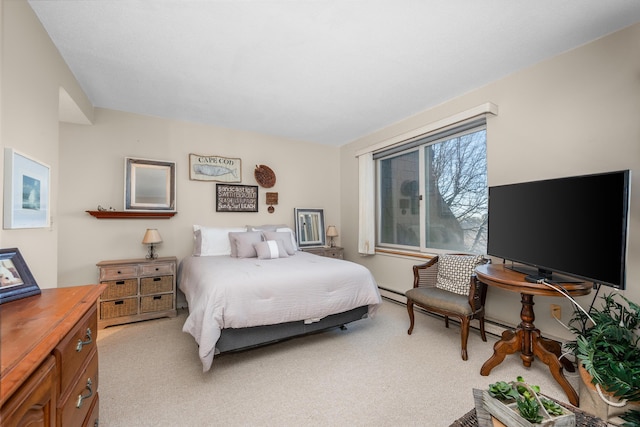 bedroom with light colored carpet and baseboard heating