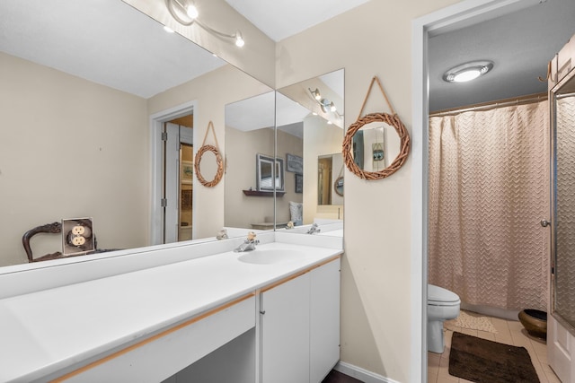 bathroom featuring curtained shower, toilet, vanity, and tile patterned flooring