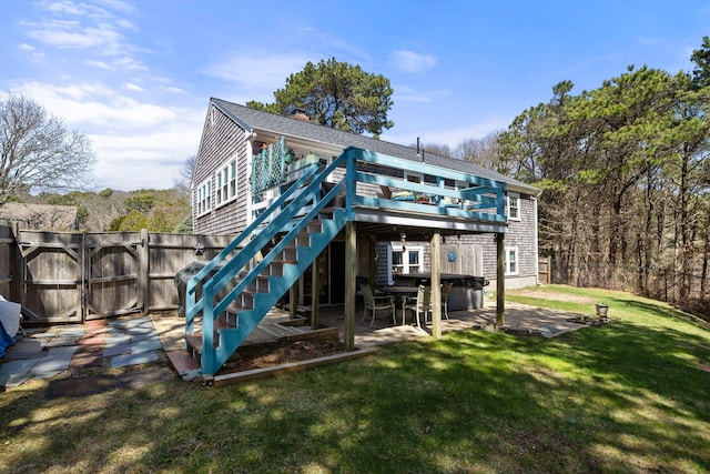 64 Gold Finch Ln, South Dennis, MA 02660 - rear view of house with a gate, a wooden deck, a lawn, a fenced backyard, and a patio area