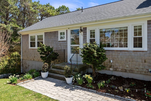 64 Gold Finch Ln, South Dennis, MA 02660 - doorway to property featuring roof with shingles