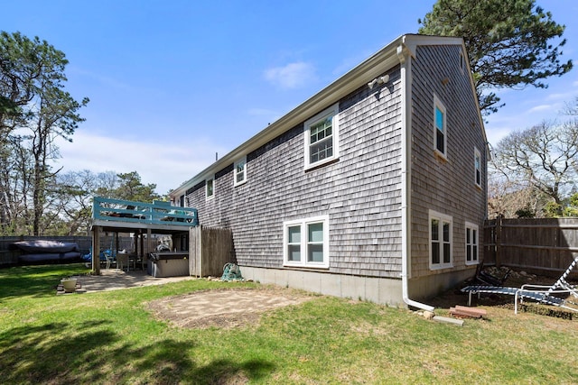 64 Gold Finch Ln, South Dennis, MA 02660 - rear view of house with a patio, fence, a wooden deck, a lawn, and a hot tub
