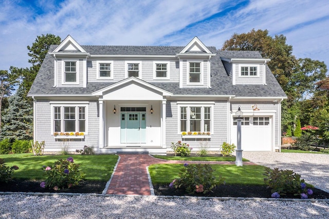 view of front of home featuring a garage and a front lawn