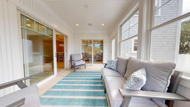 sunroom featuring a notable chandelier