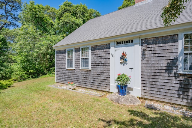 181 Stony Brook Rd, Brewster, MA 02631 - view of side of home featuring a yard, a chimney, and a shingled roof
