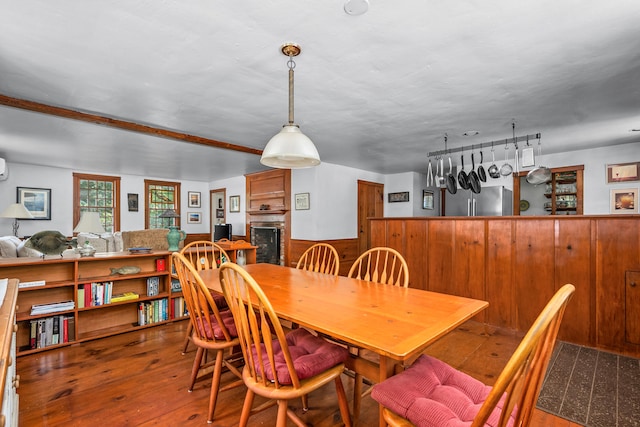 181 Stony Brook Rd, Brewster, MA 02631 - dining space featuring hardwood / wood-style flooring, wainscoting, a fireplace, and wooden walls