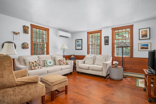 181 Stony Brook Rd, Brewster, MA 02631 - living room with a wall mounted air conditioner, a baseboard heating unit, hardwood / wood-style flooring, plenty of natural light, and a wainscoted wall