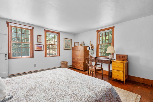181 Stony Brook Rd, Brewster, MA 02631 - bedroom featuring a baseboard heating unit, wood finished floors, and multiple windows