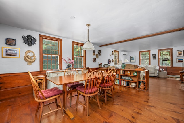 181 Stony Brook Rd, Brewster, MA 02631 - dining space with a wall mounted AC, wood finished floors, and wainscoting