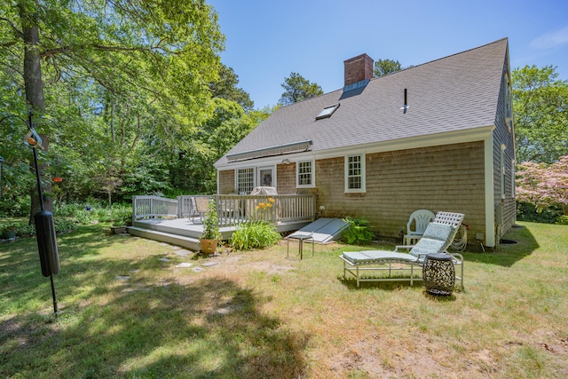 181 Stony Brook Rd, Brewster, MA 02631 - rear view of house with a shingled roof, a deck, a chimney, and a lawn