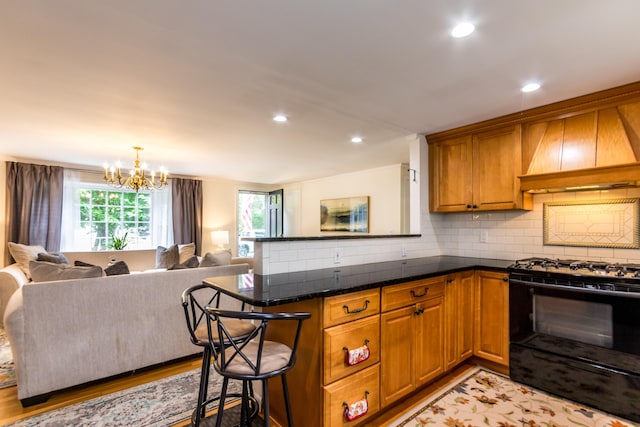 15 Mirror Brook Rd, West Yarmouth, MA 02673 - kitchen featuring premium range hood, black gas stove, healthy amount of natural light, open floor plan, and recessed lighting